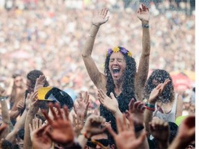 Music fans are sprayed with water as they enjoy the performance by Scottish electronic band CHVRCHES at the 2014 Osheaga Music Festival at Jean-Drapeau Park in Montreal on Sunday, August 3, 2014. Gazette photo by Dario Ayala