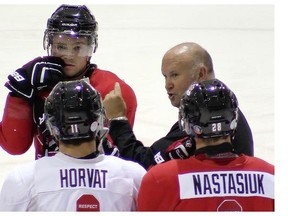 Coach Benoit Groulx speaks to his players during hockey practice on Thursday August 07, 2014 during the Canadian Junior hockey evaluation camp held in Brossard.