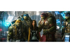 This image released by shows, from left, Michelangelo, Leonardo, Megan Fox, as April O'Neil, Raphael, and Donatello in a scene from "Teenage Mutant Ninja Turtles."