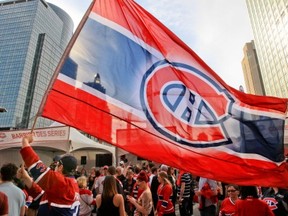 MONTREAL, QUE.: MAY 12, 2014 -- Montreal Canadiens fan Jean-Francois Gordon-Masmarti carries a Canadiens flag outside the Bell Centre prior to Game 6 of Stanley Cup playoff series against the Boston Bruins in Montreal Monday May 12, 2014.      (John Mahoney  / THE GAZETTE)