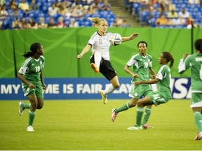 Germany’s Lena Tetermann (#18) Nigeria controls the ball before Nigeria’s Gladys Abasi (#18), Halimatu Ayinde (#10) during the FIFA U-20 Women’s World Cup Canada 2014 at the Olympic Stadium in Montreal, Quebec, Canada on August 24, 2014.  Germany scored in the eighth minute of extra time beating Nigeria 1-0 to claim the Under-20 Womens World Cup.
