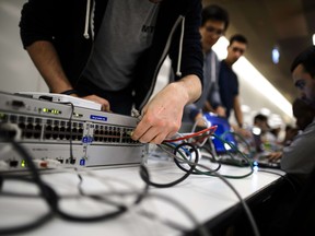 A participant connects his computer to compete in the ethical hacking contest Insomni'hack 2014 last March in Geneva. Unfortunately, news this week from a U.S. firm points out that most hacking is anything but ethical, after 1.2 billion passwords hacked by a criminal organization based in Russia. AFP PHOTO / FABRICE COFFRINIFABRICE COFFRINI/AFP/Getty Images