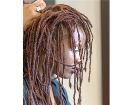 Hairstylist Yvonne Jacobs redoes the dreadlocks on her daughter Sharelle Jacobs at her salon, Eve Coiffure. “I feel good about myself, I feel like this is who I was supposed to be,” Sharelle Jacobs says.