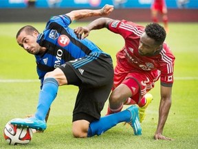 Impact’s Andres Romero, left, and Toronto FC’s Warren Creavalle battle for the ball during first-half MLS soccer action in Montreal on Saturday. Graham Hughes/The canadian press
