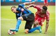 Impact’s Andres Romero, left, and Toronto FC’s Warren Creavalle battle for the ball during first-half MLS soccer action in Montreal on Saturday. Graham Hughes/The canadian press