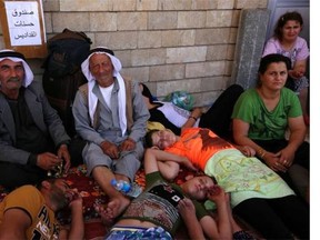 Iraqi Christians who fled the violence in the village of Qaraqush, about 30 kilometres east of the northern province of Nineveh, rest upon their arrival at the Saint-Joseph church in the Kurdish city of Arbil, in Iraq’s autonomous Kurdistan region, on August 7, 2014. Gunmen from the Sunni Muslim Islamic State (IS) seized Qaraqosh, Iraq’s largest Christian town, and several others near Mosul following the withdrawal of Kurdish peshmerga fighters, inhabitants said.