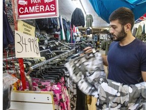 Isaak Nalpatian stocks the popular U.S.-style BDU (Battle Dress Uniform) Urban Camo pants at Canam Surplus D’Armée, which has become a popular store for police officers. The store has been forced to beef up its stock.