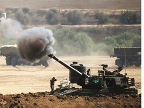 An Israeli artillery gun fires a 155mm shell towards targets from their position near Israel's border with the Gaza Strip on July 30, 2014. Israel agreed to observe a four-hour lull in Gaza several hours after a deadly strike on a school killed 16, drawing a furious response from a UN refugee agency.