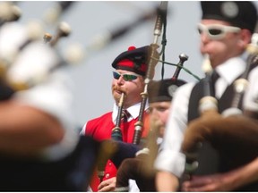 Jason Wood, centre, of the 78th Fraser Highlanders of Ottawa, takes part in the opening ceremony at the 37th edition of the Montreal Highland Games, at Arthur-Therrien Park in Verdun, Montreal, Sunday, August 3, 2014.  Pipers, other musicians and athletes from across the country participated in the games which always immediately follow the Glengarry Highland Games in Maxville, Ontario.
