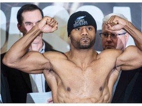 Jean Pascal flexes his muscles during a weigh-in Friday, January 17, 2014, before his unanimous 12-round decision against fellow Montrealer Lucian Bute in the WBC Diamond and NABF Light Heavyweight title fight.