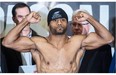 Jean Pascal flexes his muscles during a weigh-in Friday, January 17, 2014, before his unanimous 12-round decision against fellow Montrealer Lucian Bute in the WBC Diamond and NABF Light Heavyweight title fight.