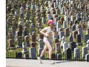A jogger goes by Notre-Dame-des-Neiges cemetery on Mount Royal.