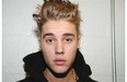 Justin Bieber, seen in a police photo in January after an illegal street race in Miami, admits to misdemeanour charges of careless driving and resisting arrest without violence.