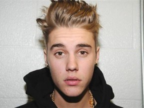 Justin Bieber, seen in a police photo in January after an illegal street race in Miami, admits to misdemeanour charges of careless driving and resisting arrest without violence.