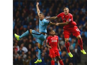 Manchester City's Montenegrin striker Stevan Jovetic (L) vies with Liverpool's Slovakian defender Martin Skrtel (R) during the English Premier League football match between Manchester City and Liverpool at the Etihad Stadium in Manchester, north-west England on August 25, 2014.