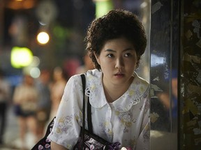 In this scene from the South Korean comedy Miss Granny, Shim Eun-kyung's character, Oh Doo-ri,  has a young face, but she hasn't yet abandoned her old-lady perm. (CJ Entertainment)