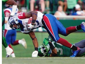 Montreal Alouettes quarterback Alex Brink (#15) is caught by Saskatchewan Roughriders defensive back Rod Williams (#37) during a game held at Mosaic Stadium in Regina, Sask. on Saturday Aug. 16, 2014.