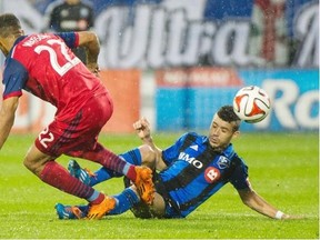 Montreal Impact’s Felipe Martins, right, and Chicago Fire’s Matt Watson battle for the ball during second half MLS soccer action at Saputo Stadium in Montreal, Saturday, Aug. 16, 2014.