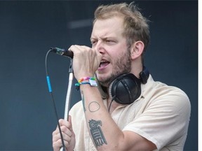 Jon Mueller of the indie rock band Volcano Choir performs with the group for the 2014 Osheaga Music Festival at Jean-Drapeau Park in Montreal on Saturday.