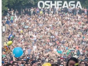 Music fans enjoy the performance by Scottish electronic band CHVRCHES at the 2014 Osheaga Music Festival at Jean-Drapeau Park in Montreal on Sunday, August 3, 2014.