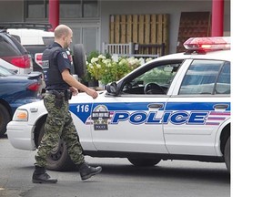 Laval police officer wears camouflage pants on Friday, Aug. 8, as part of the protest against Bill 3.