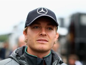 Nico Rosberg of Germany and Mercedes GP walks through the paddock after qualifying ahead of his Mercedes rival Lewis Hamilton at the Belgian Grand Prix at Circuit de Spa-Francorchamps on Saturday in Spa, Belgium.