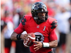 Ottawa Redblacks’ Henry Burris lines up a pass as he takes on the Calgary Stampeders during CFL action in Ottawa on Sunday, Aug. 24, 2014.