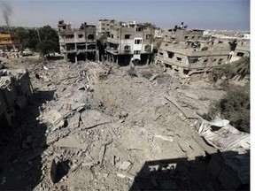 Palestinians walks across the rubble of destroyed buildings and homes in Al-Salam neighbourhood, in Jabalia in the northern Gaza Strip on August 1, 2014. A 72-hour ceasefire took effect today in Gaza but was immediately threatened by fierce clashes and deadly shelling, as diplomats pressed for a durable end to the 25-day conflict.