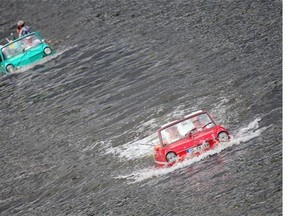 People drive with amphibian vehicles in the river Mosel near Traben-Trabach, southern Germany on August 2, 2014 during the "Amphib 2014" rally. Fans of amphibian vehicles join the event that takes place for the 4th time from August 2 to 8, 2014.