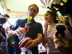 Marijuana activist Marc Emery smokes from a bong with the words 'Freedom' on it during his return party in downtown Vancouver, B.C., on Sunday. Today, delegates at the Canadian Medical Association’s general council meeting voted to formally oppose the smoking of any plant substance, saying Canadians shouldn’t smoke “any plant material” whatsoever, including marijuana.THE CANADIAN PRESS/Ben Nelms