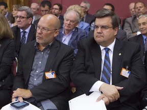 Montreal Mayor Denis Coderre, right, and Marc Ranger, left, leader of Coalition of Union Workers, listen Wednesday, August 20, 2014 at the Quebec legislature in Quebec City during hearings into Bill 3, the Quebec legislation aimed at revamping pension plans. THE CANADIAN PRESS/Clement Allard