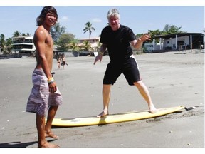 Surf instructor Fred Martines works on the unenviable task of instructing Ted Rhodes on surfing in the Nicaraguan beach village of Las Peñitas.