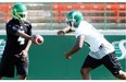 Saskatchewan Roughriders QB Darian Durant (L) with running back Jerome Messam (R) during riders practice at Mosaic Stadium in Regina on Thursday, Aug. 14, 2014.