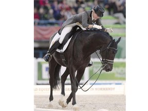 Spaniard Morgan Barbancon rides Painted Blackon August 26, 2014 during the second session of the Dressage Grand Prix of the 2014 FEI World Equestrian Games at D'Ornano Stadium in the northwestern French city of Caen.