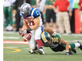 Alouettes reciever Bo Bowling drops a pass from quarterback Troy Smith while being hit by Eskimos’ Aaron Grymes at Molston Stadium in Montreal Friday Aug. 8, 2014.