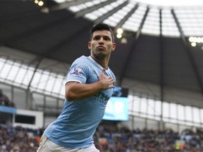 Manchester City's Sergio Aguero celebrates after scoring against Arsenal during their English Premier League soccer match at the Etihad Stadium, Manchester, England. The new English Premier League season starts on Saturday Aug. 16, 2014.