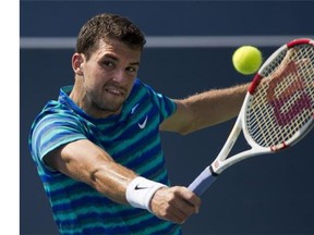 Grigor Dimitrov of Bulgaria returns the ball against Jo-Wilfried Tsonga of France during men's semifinal Rogers Cup tennis action in Toronto on Saturday, August 9, 2014. THE CANADIAN PRESS/Nathan Denette