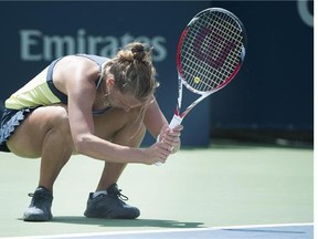 Sara Errani, of Italy, returns the ball to Sabine Lisicki, of Germany, during their opening round match at the Rogers Cup tennis tournament in Montreal, Monday, August 4, 2014. THE CANADIAN PRESS/Graham Hughes