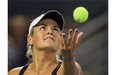 Canadian Aleksandra Wozniak tosses the ball into the air while serving during match against Sloane Stephens during Rogers Cup tennis tournament in Montreal Monday August 04, 2014.