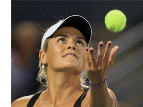 Canadian Aleksandra Wozniak tosses the ball into the air while serving during match against Sloane Stephens during Rogers Cup tennis tournament in Montreal Monday August 04, 2014.