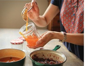 Suzanne Spahi spoons just-made apricot jam into jars at her home in Montreal  Tuesday August 12, 2014.