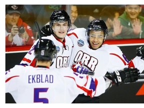 Team Orr’s Josh Ho-Sang, right, celebrates his goal with teammate Alex Peters, centre, during the CHL Top Prospects hockey action against Team Cherry in Calgary in January.