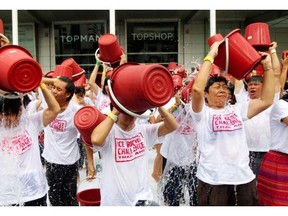 In this Friday, Aug. 22, 2014 file photo, people pour ice water over themselves during an “ice bucket challenge” fundraising event in Bangkok. About a thousand people turned out to raise money for the fight against ALS, or Lou Gehrig’s Disease.
