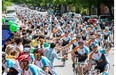 Thousands of cyclists ride up St. Hubert St. toward Mont-Royal Avenue as they take part in the Grand Défi Pierre Lavoie cycling tour in Montreal on Sunday, June 15, 2014. The event aims to encourage a healthy lifestyle through physical activity.