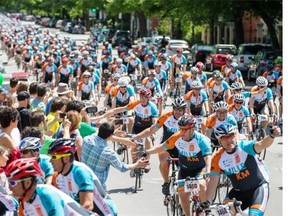 Thousands of cyclists ride up St. Hubert St. toward Mont-Royal Avenue as they take part in the Grand Défi Pierre Lavoie cycling tour in Montreal on Sunday, June 15, 2014. The event aims to encourage a healthy lifestyle through physical activity.