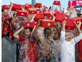 Toronto FC’s fan section know as “The Red Patch Boys” take part in the ALS ice bucket challenge after being nominated by MLSE President Tim Leiweke during the half time break following MLS action against Chicago Fire in Toronto on Saturday August 23, 2014.