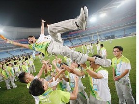 Volunteers attend a farewell party after the matches during day nine of Nanjing 2014 Summer Youth Olympic Games at the Nanjing Olympic Sports Centre on August 25, 2014 in Nanjing, China.