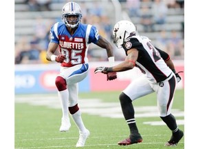 With Reggie Jones of the Ottawa Redblacks defending, Alouettes wide receiver Chad Johnson starts out on a pass route in the first half of a pre-season CFL game at Molson Stadium in Montreal, on Friday, June 19, 2014.