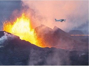 An aerial picture taken on Sept. 14, 2014, shows a plane flying over the Bardarbunga volcano spewing lava and smoke in southeast Iceland. The Bardarbunga volcano system has been rocked by hundreds of tremors daily since mid-August, prompting fears the volcano could explode. The 2,000-metre-tall Bardarbunga is Iceland’s second-highest peak and is located under Europe’s largest glacier, Vatnajoekull.