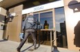 An agent from the Competition Bureau enters a building that houses the offices of Dessau, an engineering company, in Laval on Tuesday, November 6, 2012. The firm was one of four targeted by UPAC, the anti-corruption arm of the SQ.